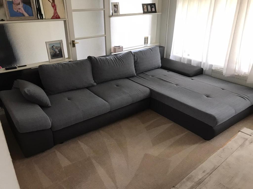 This is a photo of a grey L shape sofa that has been professionally steam cleaned, also the beige carpets have been steam cleaned too works carried out by Mill Hill Carpet Cleaning.